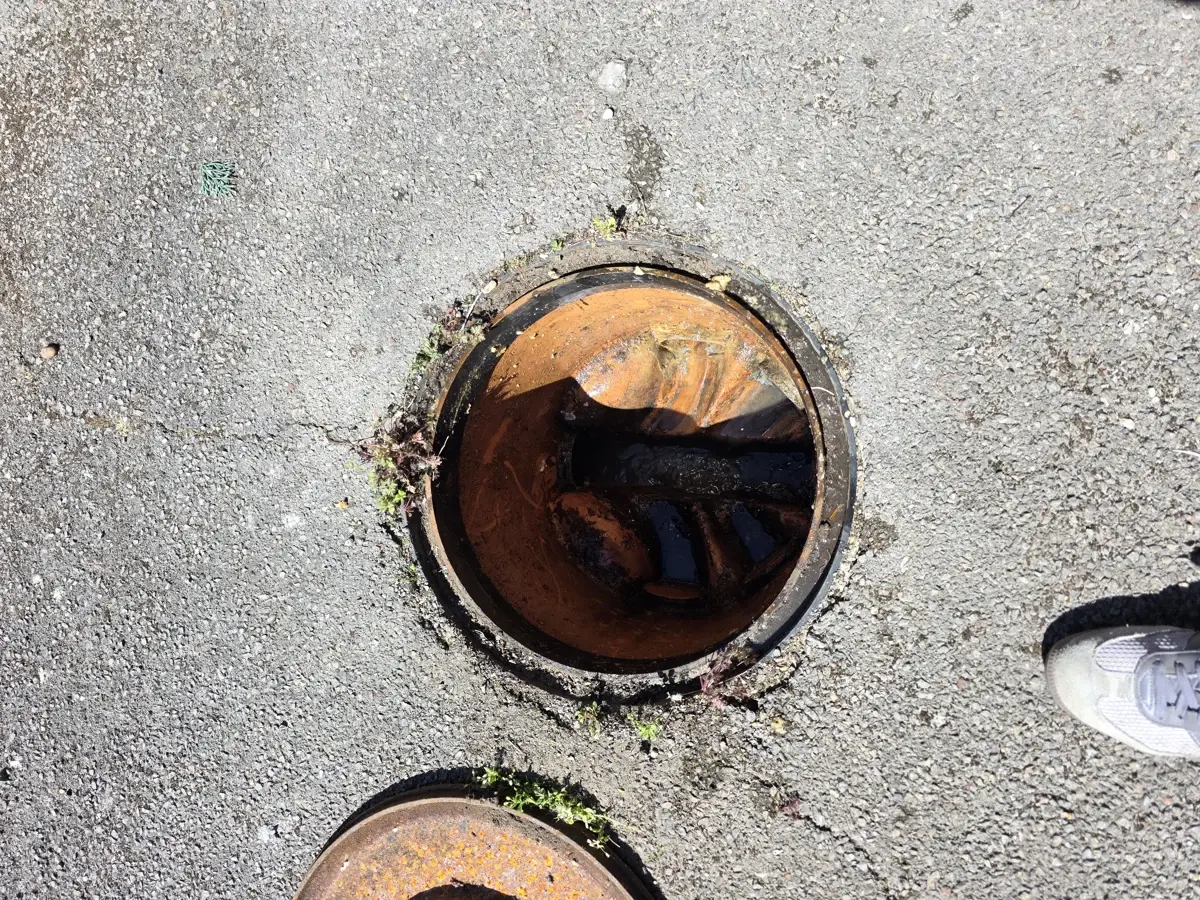 Open outdoor drain inspection chamber after unblocking